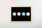 Feedback, vote, Rating, review concept. Four pastel Star Shapes on blackboard nameplate on light