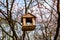 Feeder with roof for birds. House for feeding birds in the forest