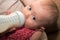 Feeding baby with infant formula in bottle