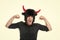 Feeling so angry. Man shouting face wears hat of devil with horns. Guy black shirt angry aggressive demonstrate strength