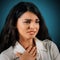 Feeling Anxious. Portrait of a beautiful young woman with in anxious mood, blue background