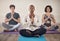 Feeling centred. Full length shot of a diverse group of yogis sitting together and meditating after an indoor yoga