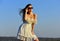 Feeling flirty. sexy girl with brunette hair on sky background. perfect sunset or sunrise. pretty woman wear sunglasses