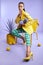 Feeling fruity. Full length studio portrait of an attractive young woman dressed in funky attire against a purple