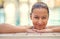 Feeling good after a long swim. a young woman relaxing in the pool at a spa.