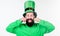 Feeling playful. Happy bearded man celebrating saint patricks day. Irish man with beard wearing green. Hipster in