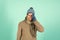 Feeling sorry. Man handsome unshaven guy wear winter accessories on blue background. Winter season sale. Hipster knitted
