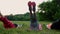 Feeling your abs girls. Group of young athletic people in sportswear doing physical exercises on green grass in summer