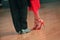 Feet of Argentinian tango dancers on a dancing parquet