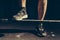 Feet athlete on the barbell. Athlete preparing to lift weights. Toned image.