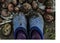 Feet in blue galoshes. Potato harvesting. Autumn potato harvest