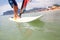 Feet on the board of windsurfing