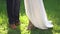 Feet of the bride and groom standing side by side on the grass