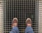 Feet with brown shoes on standing on the on the metal lattice under which is the Elevator shaft