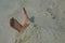 Feet buried in the sand