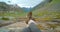 Feet of a carefree woman enjoying a landscape view of a beautiful valley while hiking and exploring on a journey of