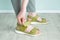 Feet a caucasian woman fastens sandals with Velcro