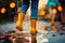 Feet of child in rubber boots jumping over a puddle in the rain