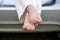 Feet of a child sitting in the trunk of a car