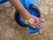 the feet of a child wearing sandals pedaling