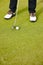 Feet, club and ball for sports on golf course, training and practice for competition or tournament. Closeup, shoes and