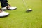 Feet, club and golf ball for sports on field, training and practice for competition or tournament. Closeup, shoes and