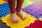 Feet correction and massage - child walking on orthopedic floor mat