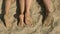 Feet of couple, sand.