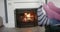 Feet of couple in socks relaxing at home in front of open fire, slow motion
