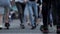 Feet crowd view walking blurred pedestrians crossing street slow motion city life. Low angle view of legs and feet of