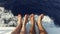 Feet on deck of sailboat or yacht sailing in sea