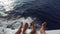 Feet on deck of sailboat or yacht sailing in sea