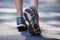 Feet, fitness and person in the road for walking, exercise and training. Active, sports and closeup of the shoes of a