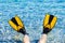 Feet in flippers fins on sea shore