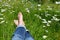 Feet on a flower meadow