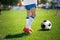 Feet of football player with soccer ball. Soccer player closeup