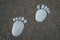 Feet, footsteps made of stones, stone footprint -