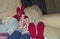 Feet of friends in christmas socks on sofa