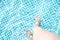 Feet of a girl in a pool with clear water