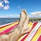 Feet in the hammock against the sea