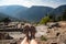 Feet hanging over ancient site of Delphi, Greece