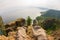 Feet hanging over the cliff rock top view. Baikal