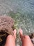 Feet hanging over ocean Nice France