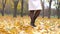 Feet Lady In Pantyhose And Black Boots Is On The Autumn Carpet Of Yellow Foliage