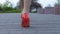 Feet of lady walking street in red high heel shoes alone, risk of attack, danger