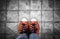 Feet in leather sneaker on pavement background