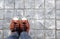 Feet in leather sneaker on pavement background