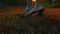 Feet legs walks on colorful red green autumn grass rear view. Calves of a child in sneakers forest walking. Kid running