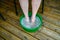 Feet in little plastic tub on wooden decking