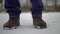 Feet of a man freezing from the cold and shifting from foot to foot